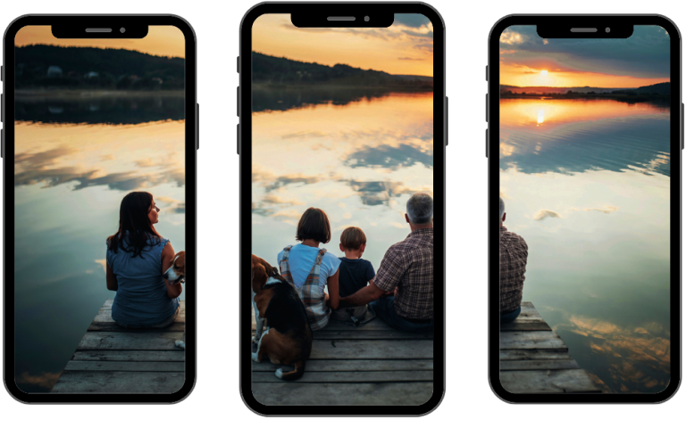 There are three phones next to each other.
 The first phone has one woman, the second having another
 woman, a dog, child, and half an old man, and the third phone
 containing the other half of the old man.On all three
 phones the people, you can only see the people and dogs
 back and they are on a dock looking into aorange sunset.